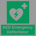 green-background-with-white-text-and-heart-defibrillator-symbol--white-cross-and~
